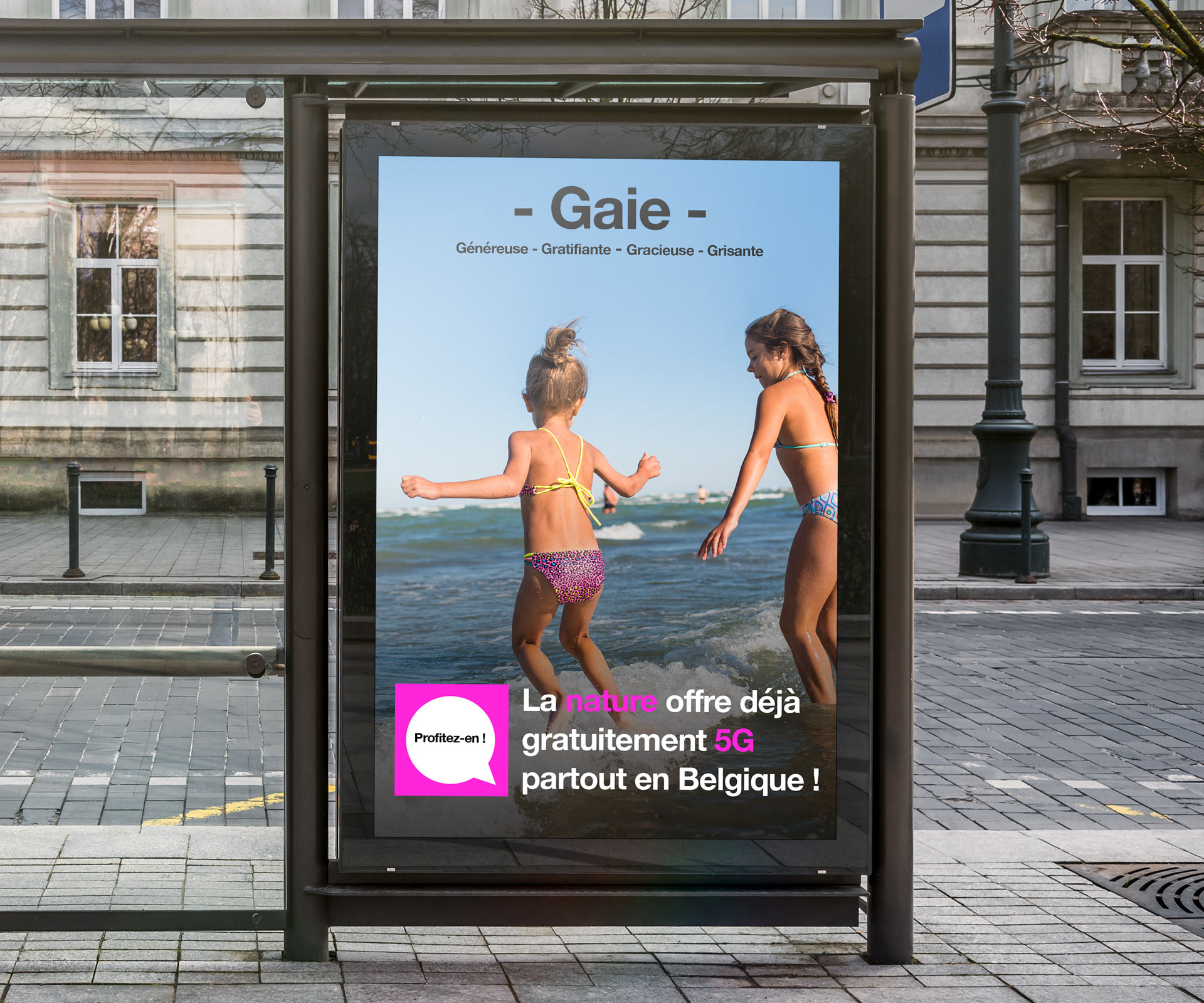 Poster in a bus stop showing girls playing in the waves