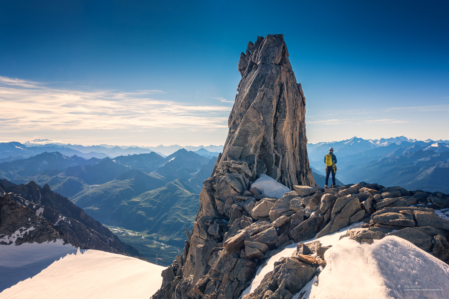 Mountaineer on top of the mountain looking far away
